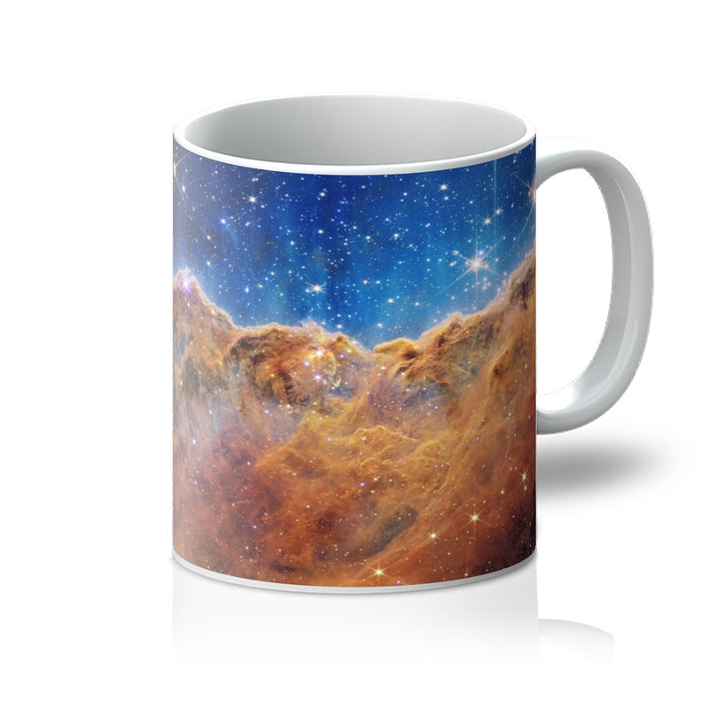 Cosmic Cliffs 11oz white mug printed with the Carina Nebula, handle on the right