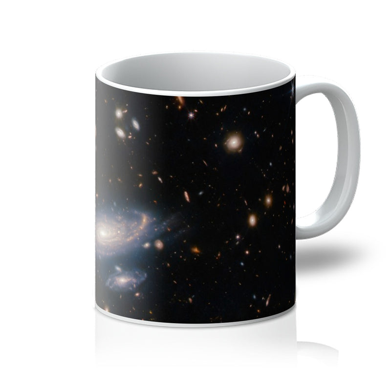 Spiral Amongst Thousands 11oz white mug printed with a spiral galaxy among distant galaxies, handle on the right