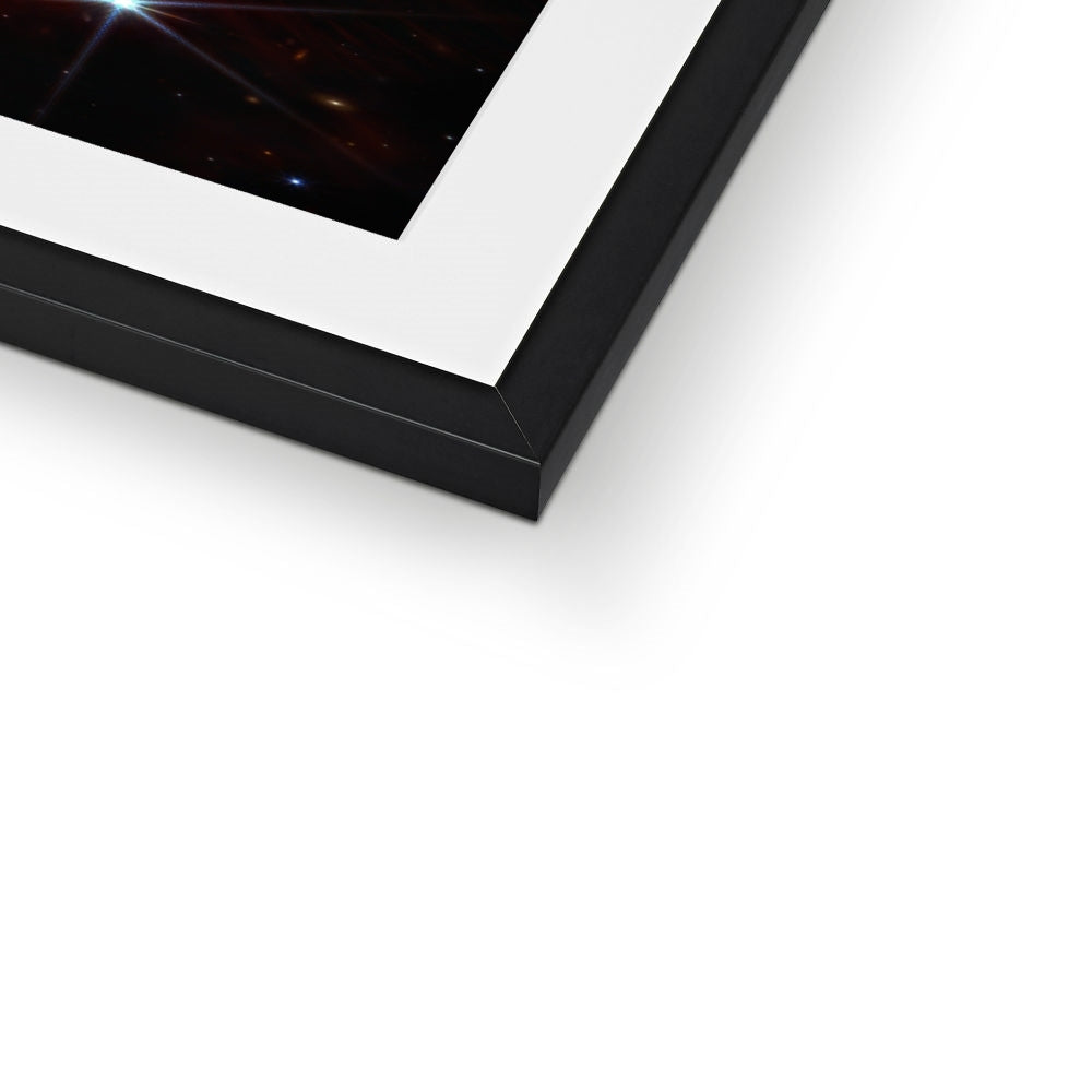 Close-up of the bottom corner of a Southern Ring Nebula framed print showing the black frame and white mount