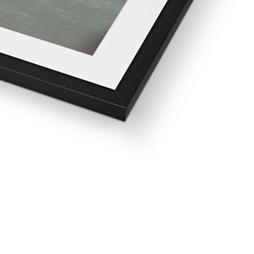 Close-up of the bottom corner of an Apollo 11 Lunar Module framed print showing the black frame and white mount