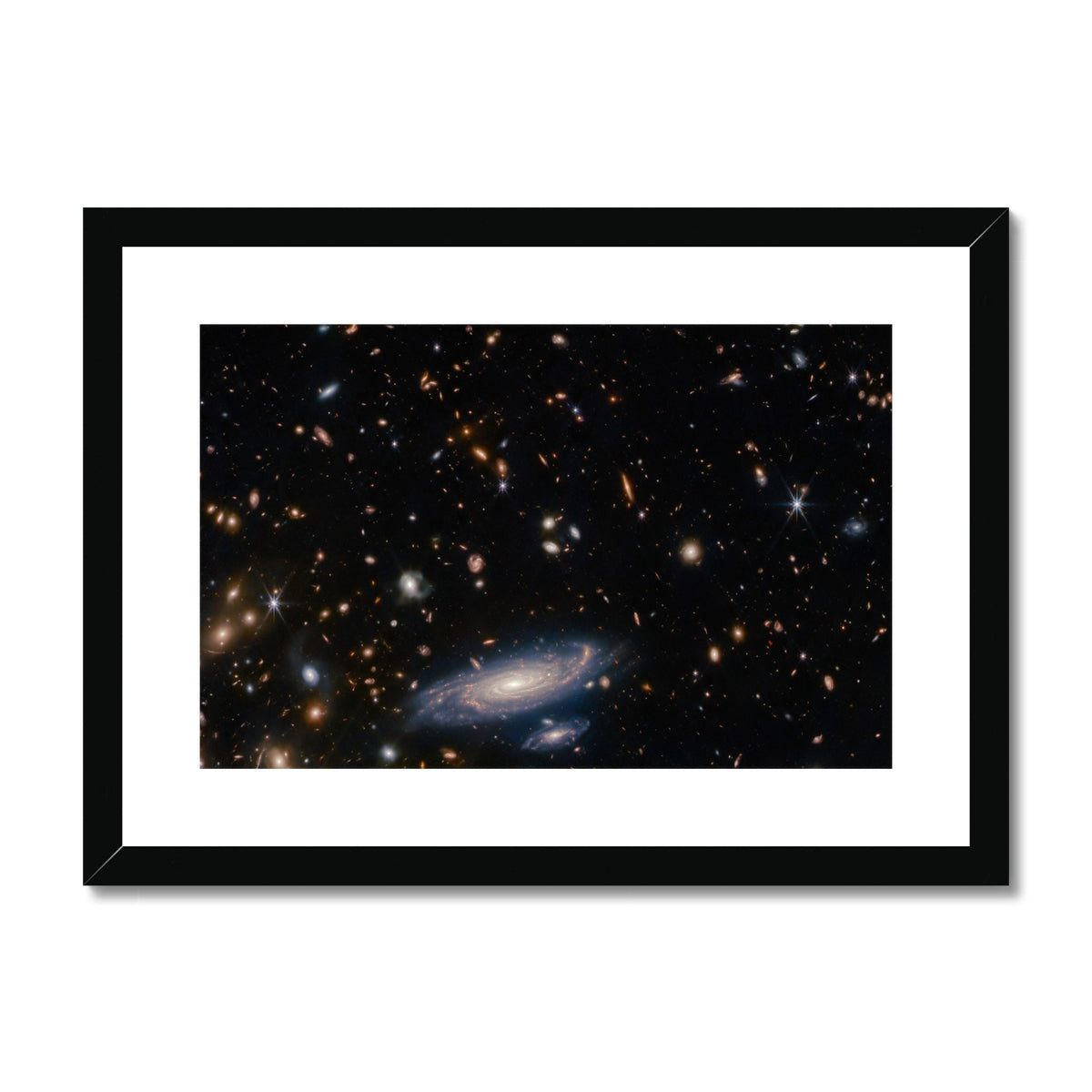 Spiral Amongst Thousands framed and mounted print showing a spiral galaxy among distant galaxies in a black frame, front view