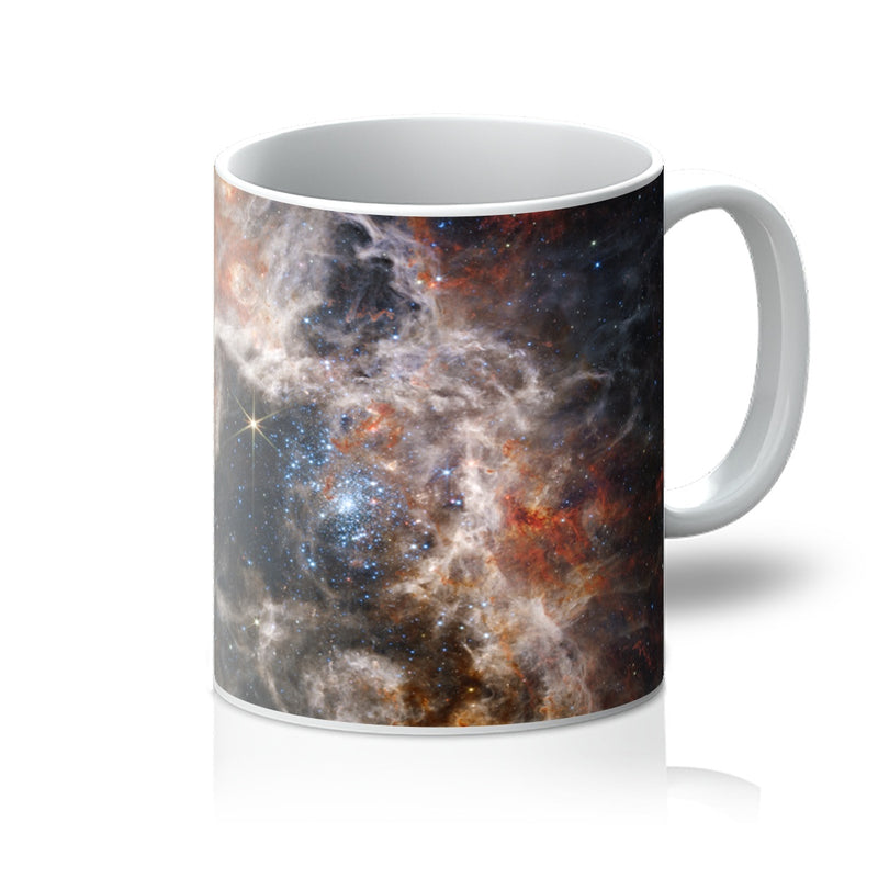 Tarantula Nebula 11oz white mug printed with swirling clouds of gas and glowing stars, handle on the right