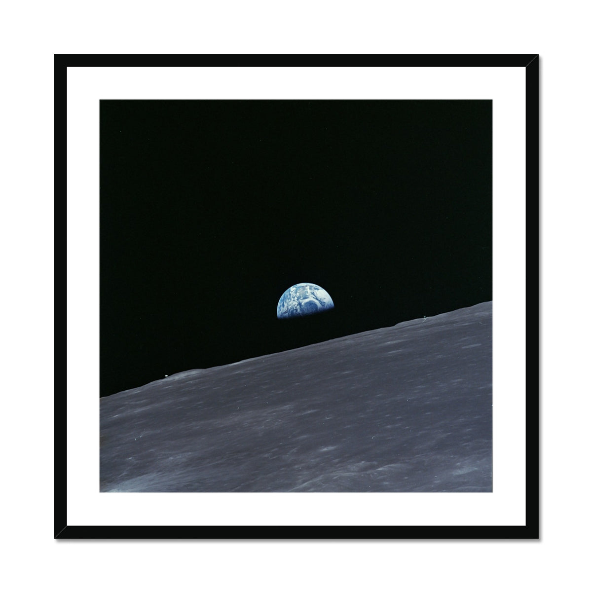 Earthrise square framed and mounted print showing Earth rising over the Moon's horizon in a black frame, front view