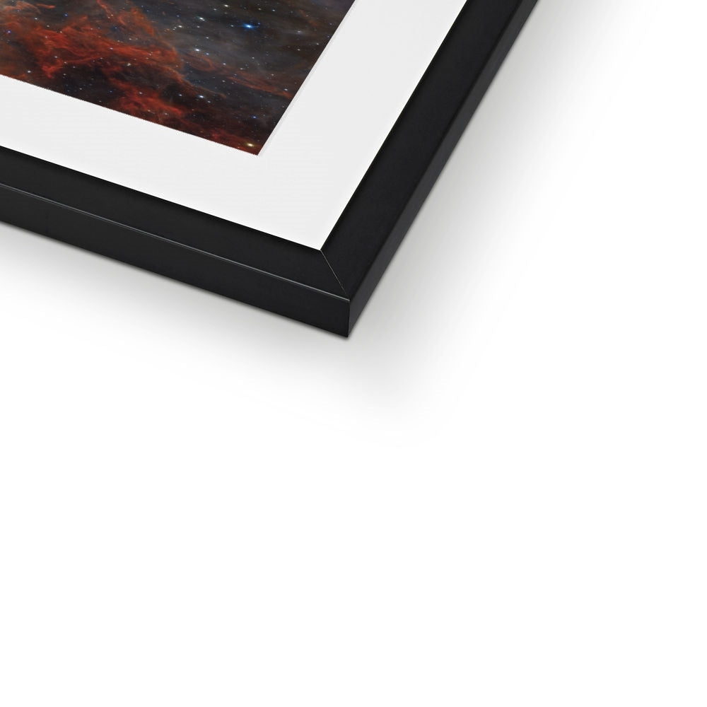 Close-up of the bottom corner of a Tarantula Nebula framed print showing the black frame and white mount