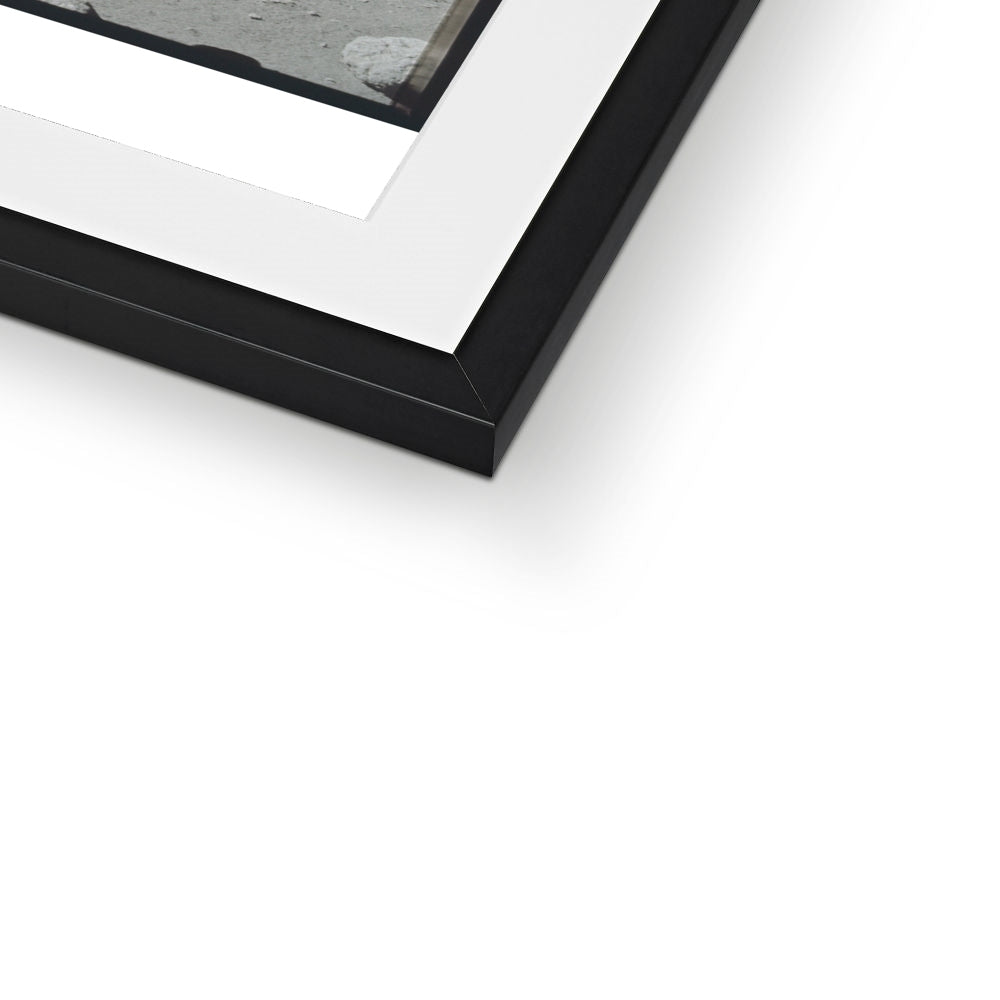 Close-up of the bottom corner of a North Massif Boulder framed print showing the black frame and white mount
