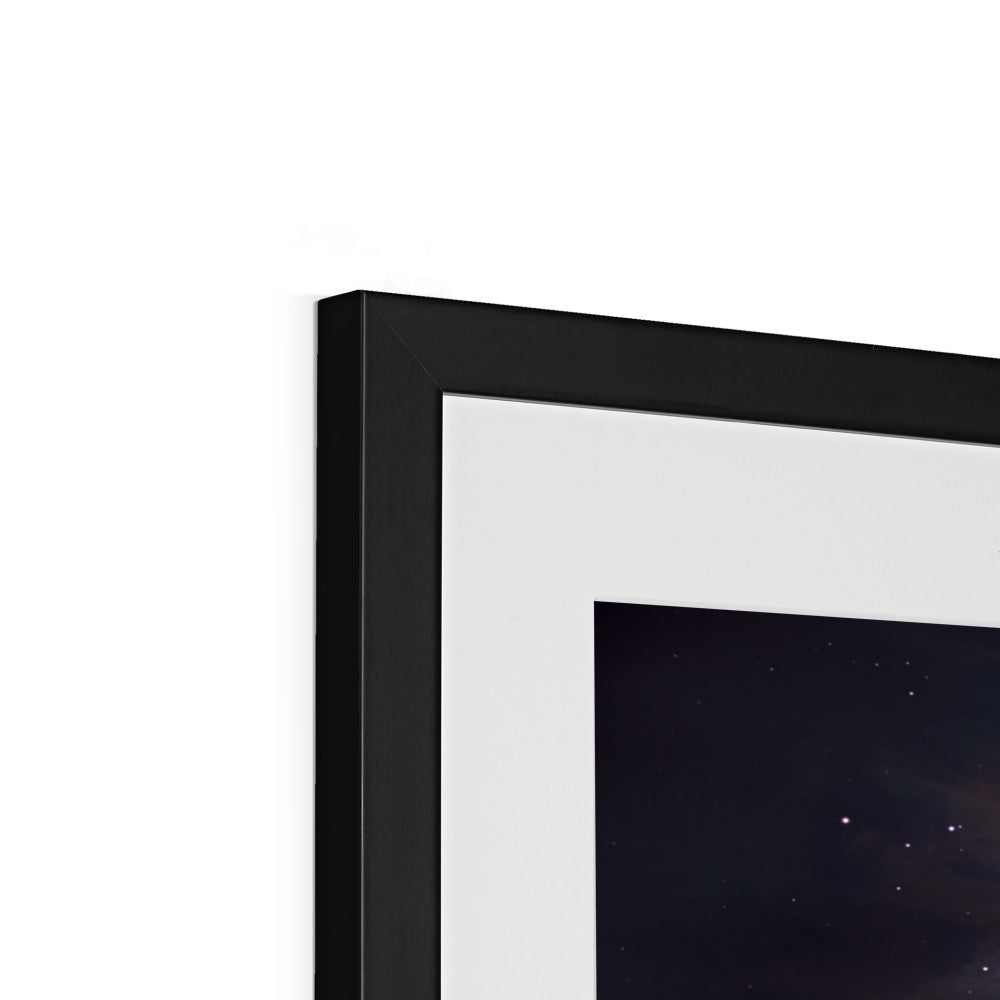 Close-up of the top corner of an Orion Nebula framed print showing the black frame, white mount and image