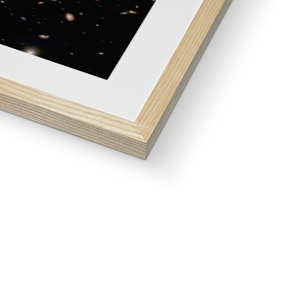 Close-up of the bottom corner of a Spiral Amongst Thousands framed print showing the natural wood frame and white mount