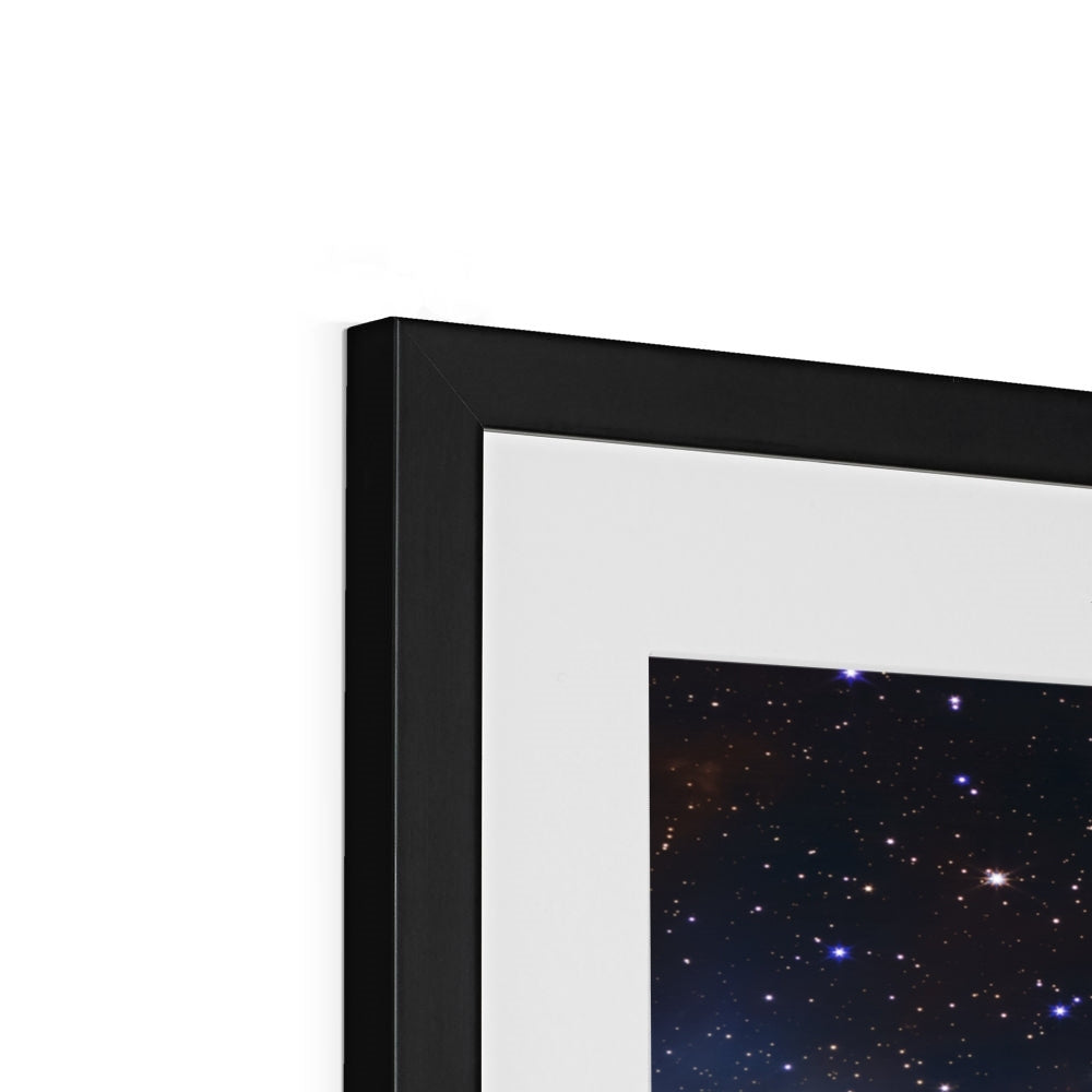 Close-up of the top corner of a Cosmic Cliffs framed print showing the black frame, white mount and image
