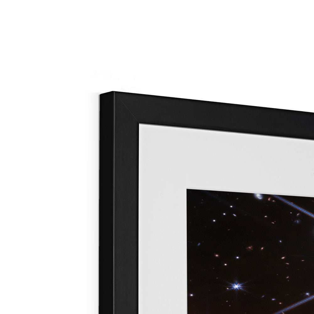 Close-up of the top corner of a Behind the Horsehead Nebula framed print showing the black frame, white mount and image