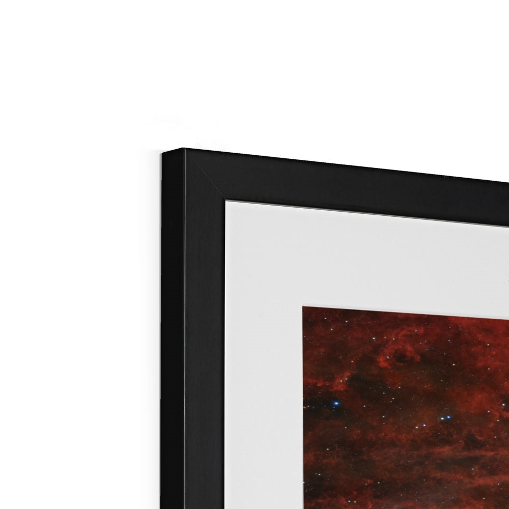 Close-up of the top corner of a Tarantula Nebula framed print showing the black frame, white mount and image